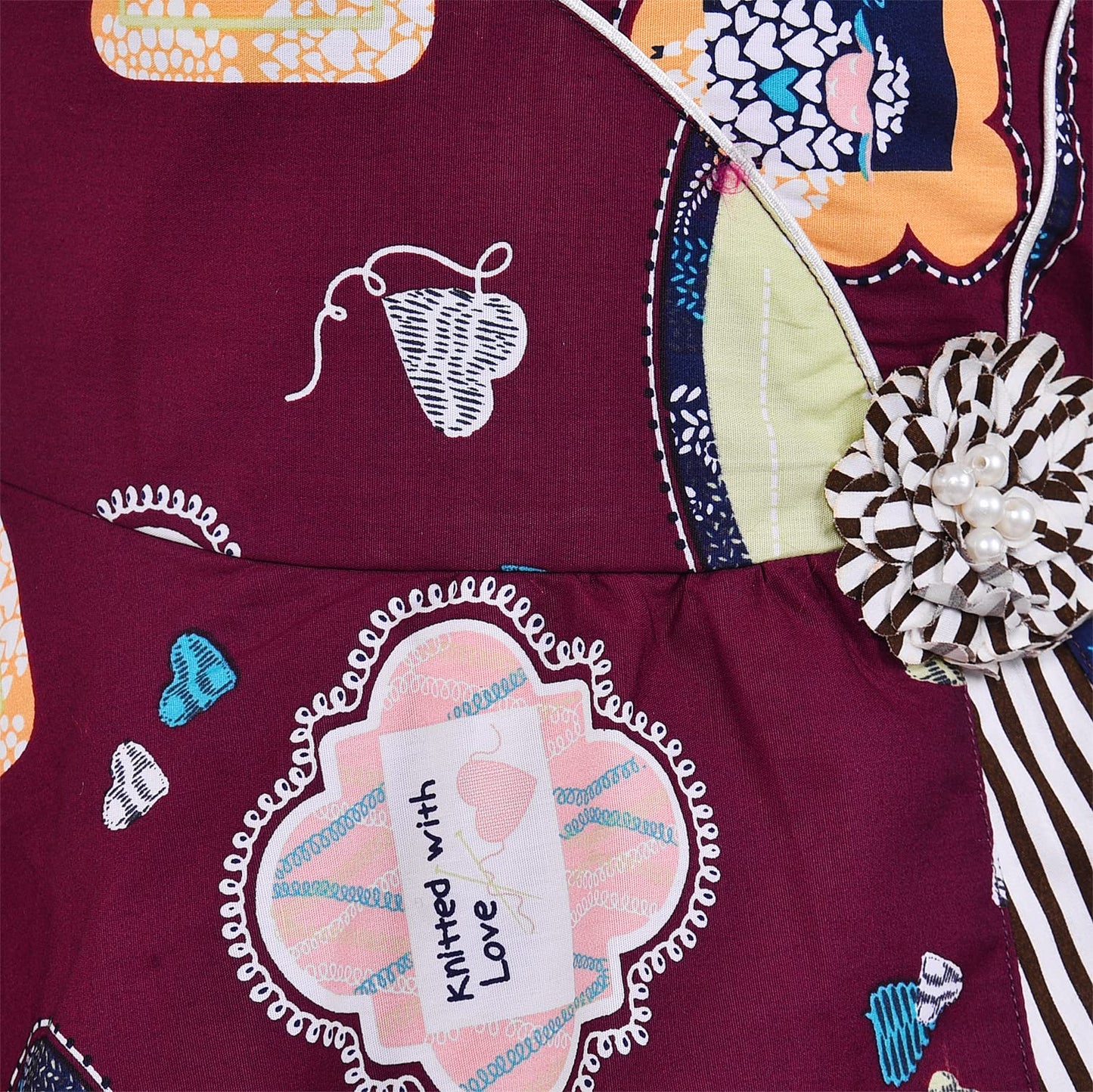 Girls Maroon Printed Cotton Dress with Asymmetrical Panel & Floral Accent ctn557